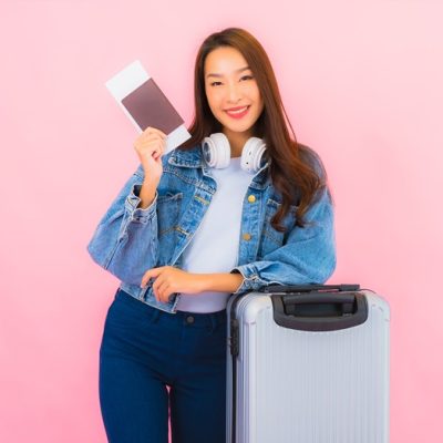 Portrait beautiful young asian woman backpack or luggage with camera ready for travel in vacation on pink background